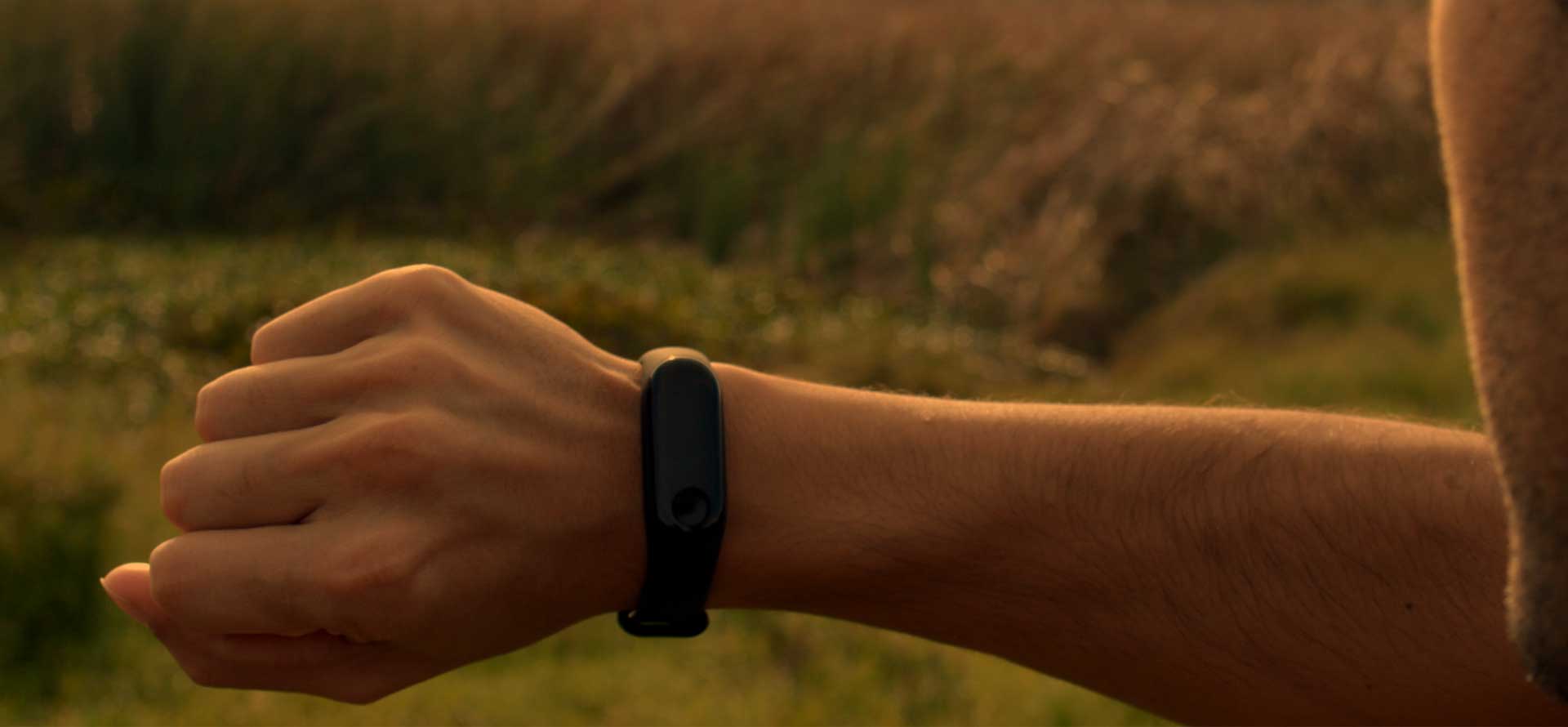 Photo of man looking at a fitness activity tracker on his arm